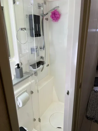 Jamsam Yacht Photos Pics Bathroom shower in a 2017 Leopard 51 Powercat yacht, featuring modern fixtures and a glass door.