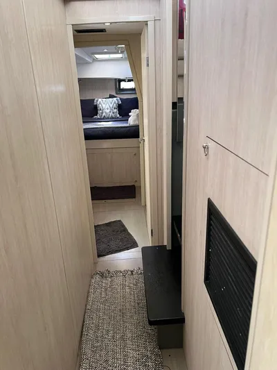 Jamsam Yacht Photos Pics Interior hallway of 2017 Leopard 51 Powercat, featuring modern design and cozy bedroom view.