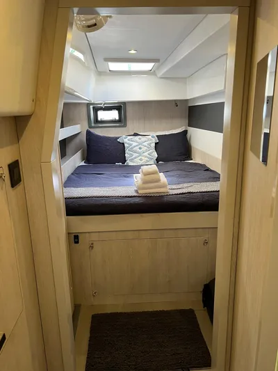 Jamsam Yacht Photos Pics Cozy cabin interior of 2017 Leopard 51 Powercat with neatly arranged bed and modern decor.