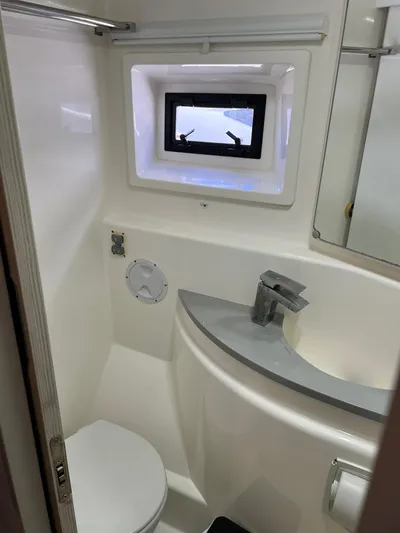 Jamsam Yacht Photos Pics 2017 Leopard 51 Powercat bathroom with modern fixtures and a small window.