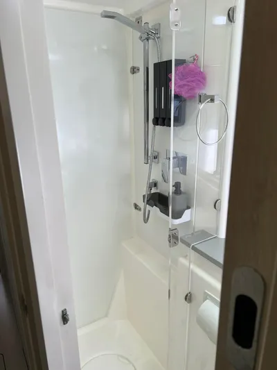 Jamsam Yacht Photos Pics Shower area in 2017 Leopard 51 Powercat, featuring glass door and modern fixtures.