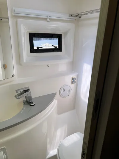 Jamsam Yacht Photos Pics Bathroom interior of 2017 Leopard 51 Powercat with modern fixtures and window.