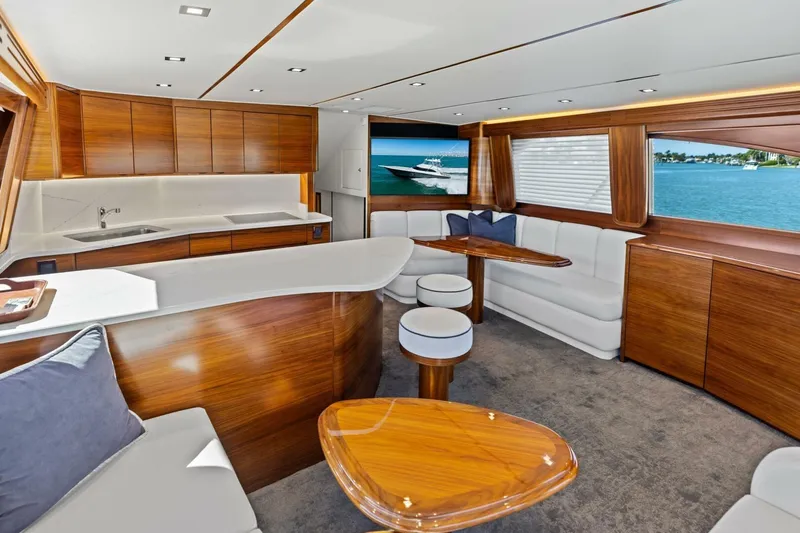 Olde Floridian Yacht Photos Pics Luxurious 2023 Vikiing convertible yacht interior with elegant wood finishes and ocean view.