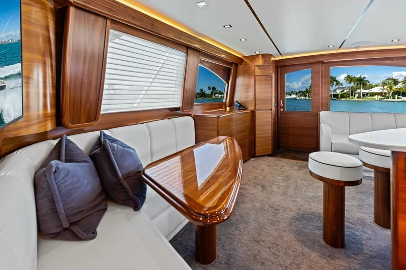Olde Floridian Yacht Photos Pics Luxurious interior of 2023 Vikiing convertible yacht with elegant wood finishes and plush seating.