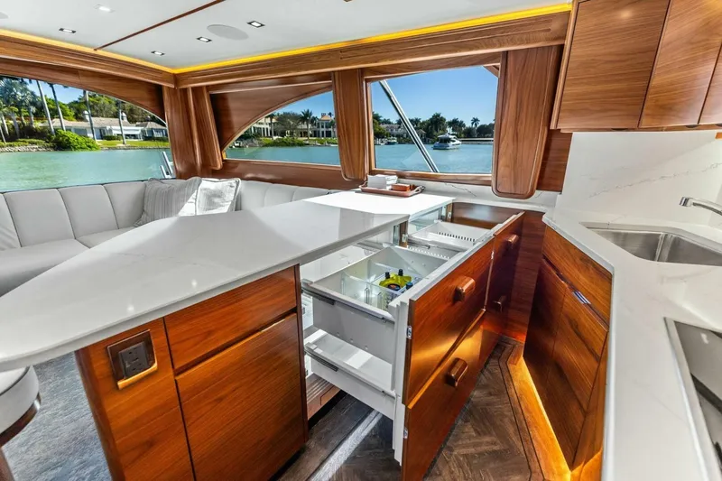 Olde Floridian Yacht Photos Pics Luxurious 2023 Vikiing convertible yacht interior with modern kitchen and scenic water view.