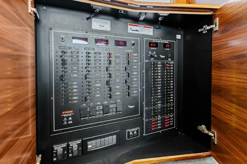 Olde Floridian Yacht Photos Pics Electrical control panel inside 2023 Vikiing convertible, featuring switches and digital displays.
