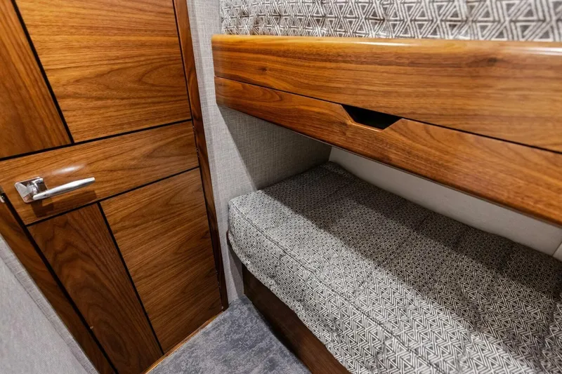 Olde Floridian Yacht Photos Pics 2023 Vikiing convertible interior with wooden cabinetry and patterned upholstery.