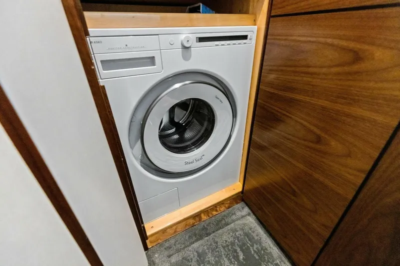 Olde Floridian Yacht Photos Pics Front-loading washing machine in a wooden cabinet, 2023 Vikiing convertible model.