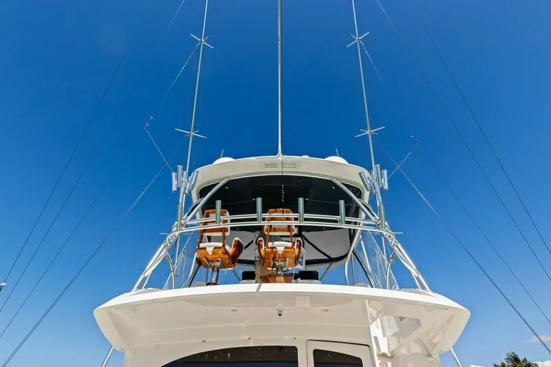 Olde Floridian Yacht Photos Pics 2023 Vikiing convertible yacht with fishing chairs and antennas against clear blue sky.
