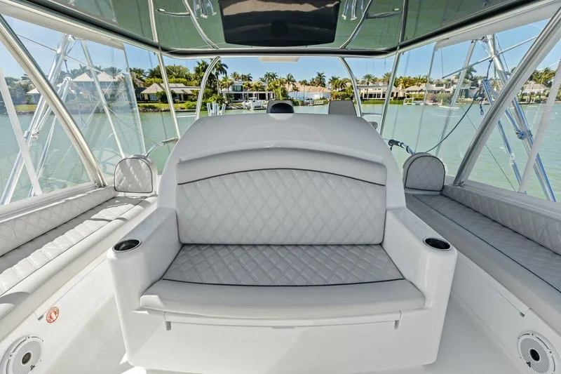 Olde Floridian Yacht Photos Pics Luxurious interior of 2023 Vikiing convertible boat with plush seating and scenic water view.