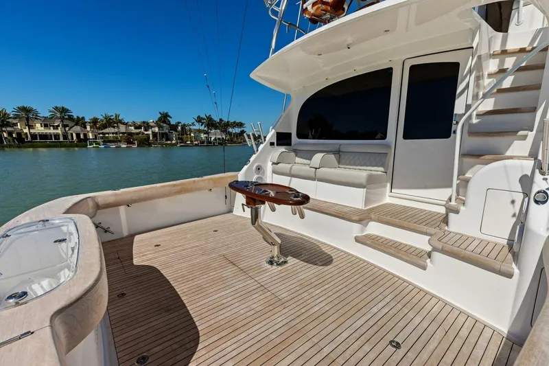 Olde Floridian Yacht Photos Pics Luxurious 2023 Vikiing convertible yacht deck with seating and scenic waterfront view.