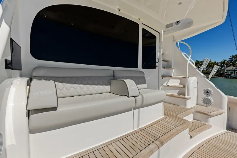 Olde Floridian Yacht Photos Pics Luxurious 2023 Vikiing convertible yacht interior with elegant seating and wooden steps.