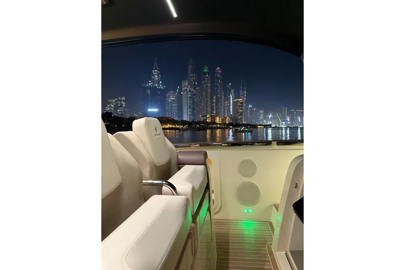  Yacht Photos Pics 2024 Invictus TT460 yacht interior with city skyline at night.