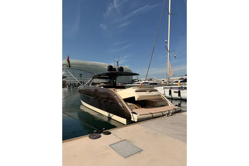  Yacht Photos Pics 2024 Invictus TT460 yacht docked at marina under clear blue sky.