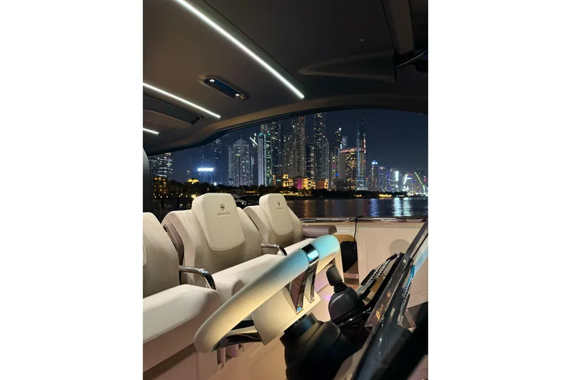  Yacht Photos Pics Interior of 2024 Invictus TT460 yacht with city skyline at night.