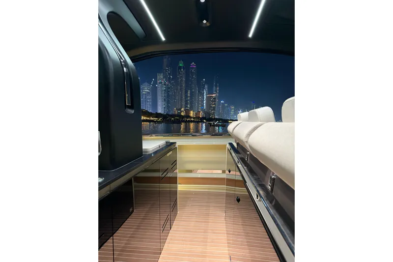  Yacht Photos Pics Interior of 2024 Invictus TT460 yacht with city skyline view at night.