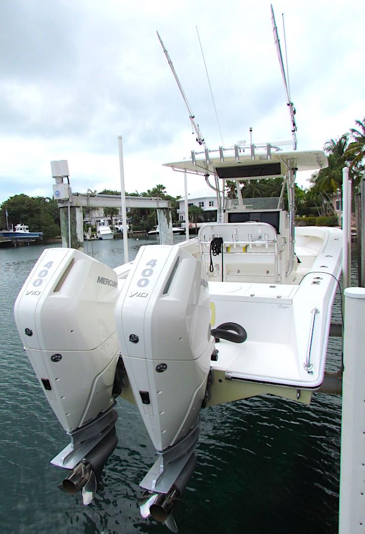 2005 Venture 34 Open boat with twin Mercury engines docked in a marina.