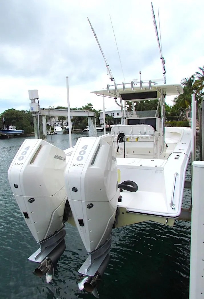 2005 Venture 34 Open boat with twin Mercury engines docked in a marina.