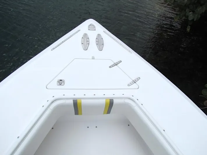  Yacht Photos Pics Bow of 2005 Venture 34 Open boat, white deck, near water.