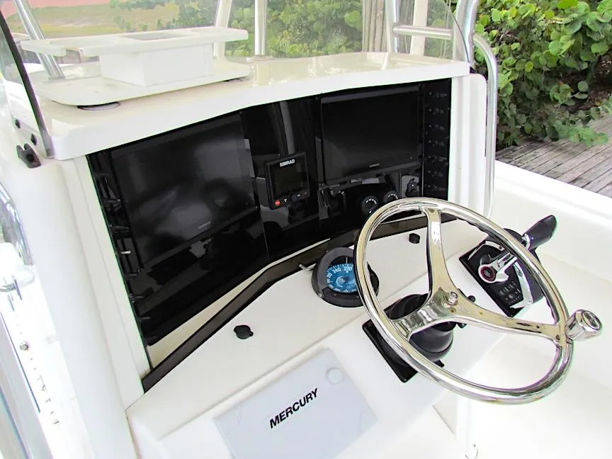 2005 Venture 34 Open boat dashboard with steering wheel and Mercury controls.