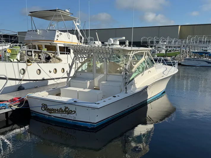 Stewartship Yacht Photos Pics 2007 Albemarle 410 Express Fisherman boat docked in a marina, clear sky reflection.