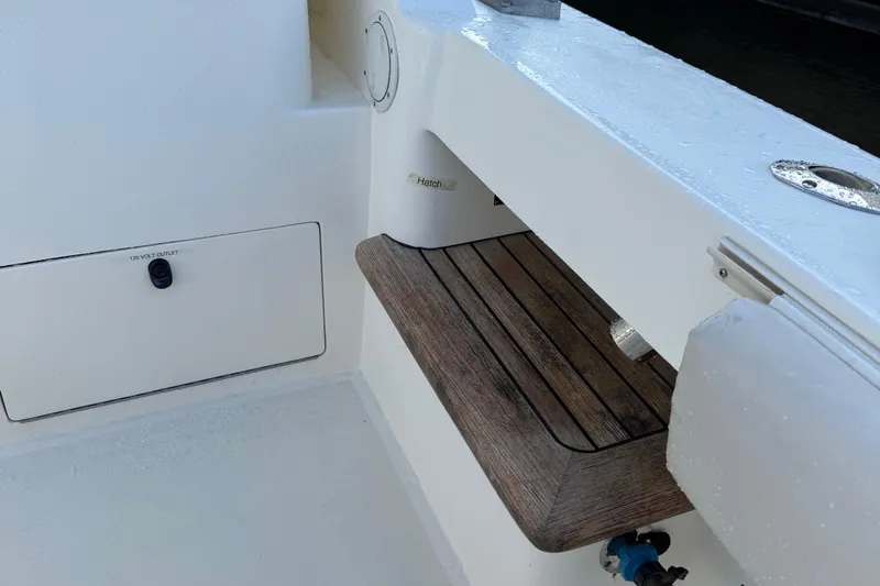 Stewartship Yacht Photos Pics 2007 Albemarle 410 Express Fisherman boat deck with wooden seat and storage compartment.