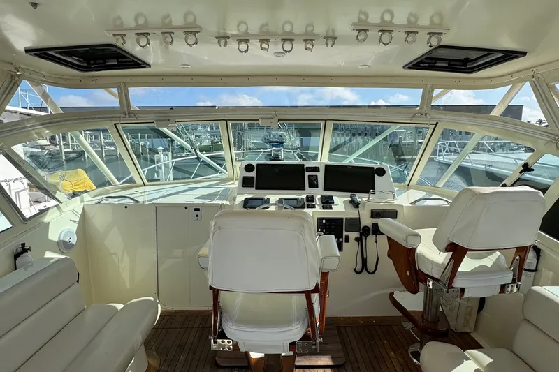 Stewartship Yacht Photos Pics 2007 Albemarle 410 Express Fisherman helm with white seating and navigation equipment.