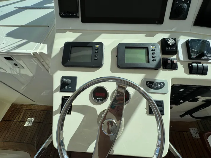 Stewartship Yacht Photos Pics Helm of 2007 Albemarle 410 Express Fisherman with navigation instruments and steering wheel.