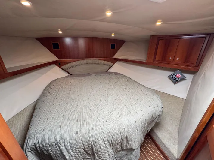 Stewartship Yacht Photos Pics Cozy cabin interior of 2007 Albemarle 410 Express Fisherman with wood accents and bed.