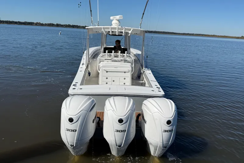  Yacht Photos Pics 2022 Regulator 34 boat with triple 300 horsepower engines on calm water.