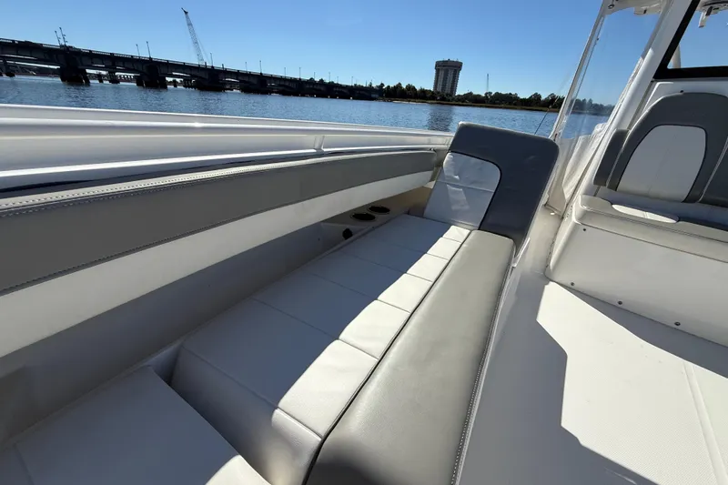  Yacht Photos Pics 2022 Regulator 34 boat interior with comfortable seating, overlooking a scenic waterfront.