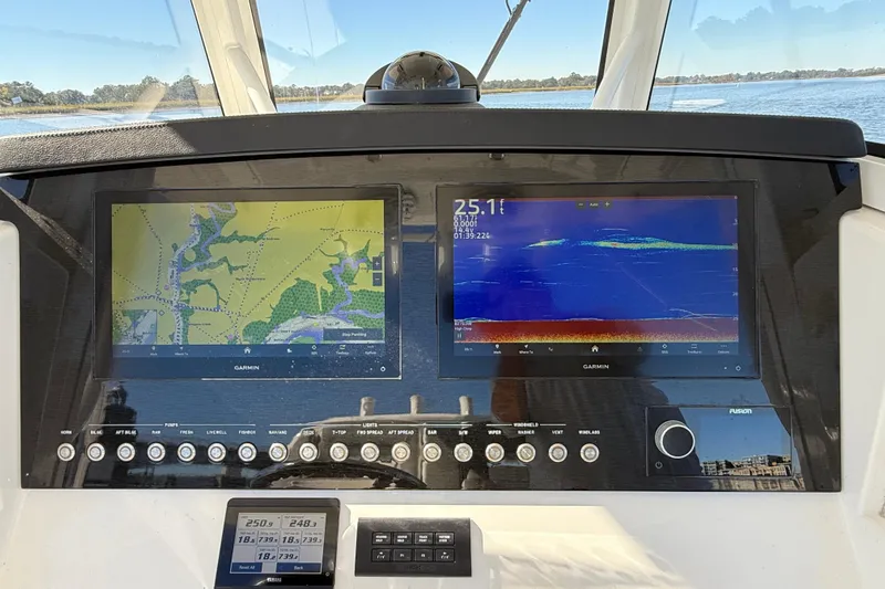  Yacht Photos Pics 2022 Regulator 34 boat dashboard with dual Garmin navigation screens and control panel.