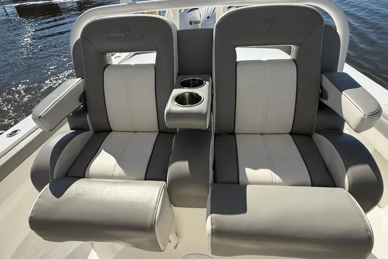  Yacht Photos Pics 2022 Regulator 34 boat seats with cup holders, featuring gray and white upholstery.