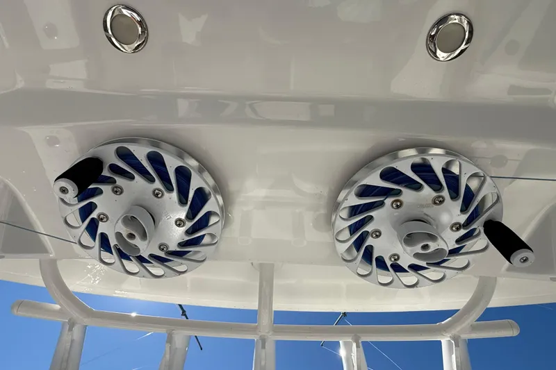  Yacht Photos Pics 2022 Regulator 34 boat with dual fishing reel holders on white deck.