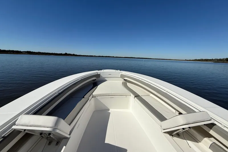  Yacht Photos Pics 2022 Regulator 34 boat on calm water under clear blue sky.