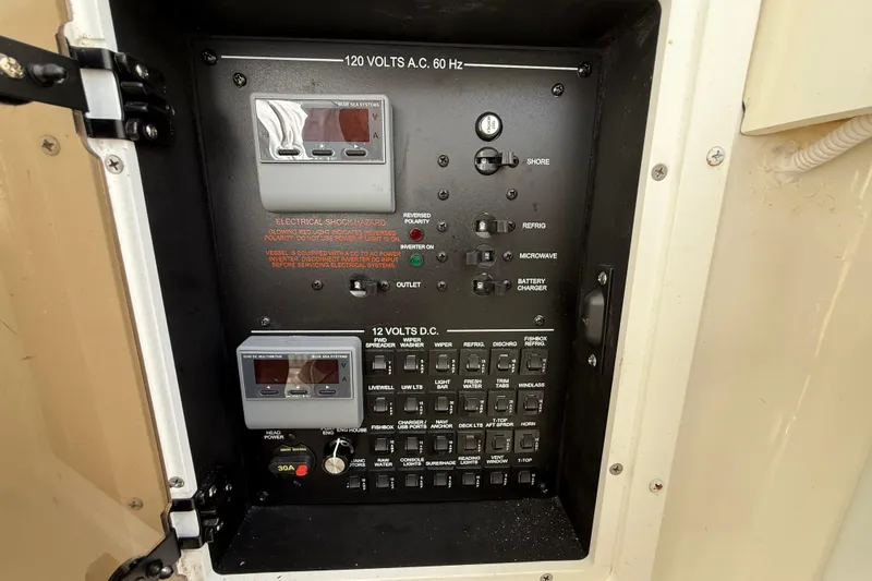  Yacht Photos Pics Electrical control panel on a 2022 Regulator 34 boat, featuring AC and DC switches.