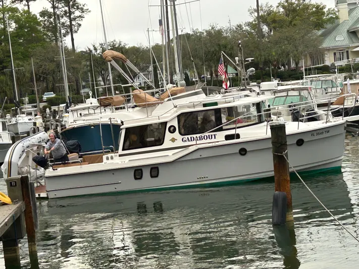 Gadabout Yacht Photos Pics 2024 Ranger Tugs R-29 CB boat docked in a marina with a person onboard.