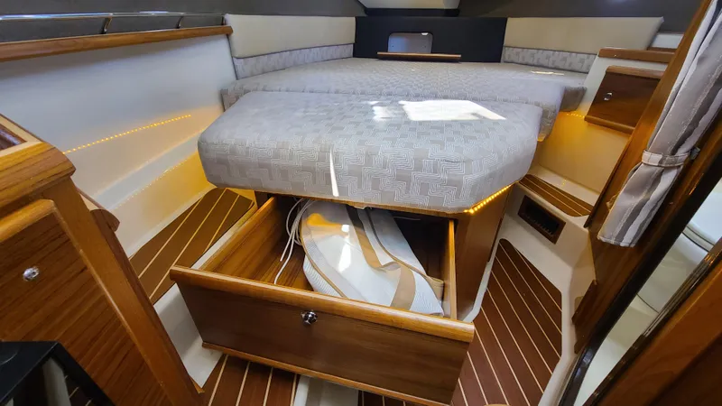 Gadabout Yacht Photos Pics 2024 Ranger Tugs R-29 CB cabin interior with bed and storage drawer open.
