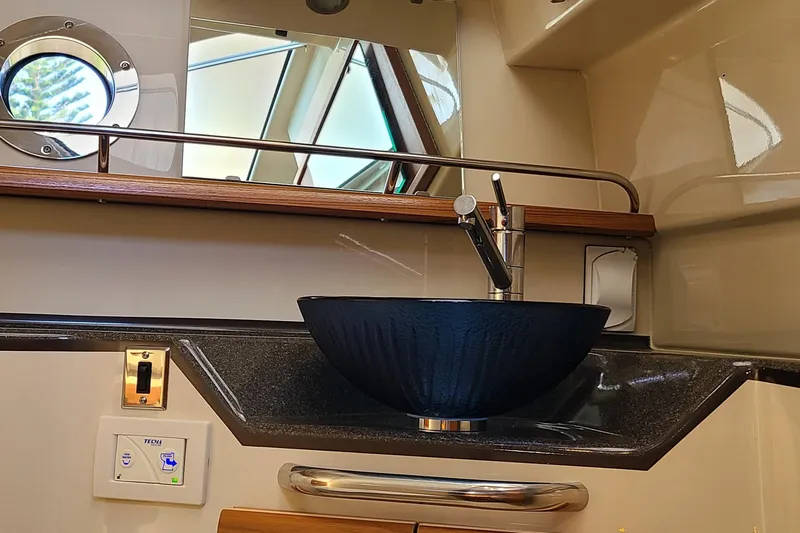 Gadabout Yacht Photos Pics 2024 Ranger Tugs R-29 CB bathroom with modern sink and porthole window.