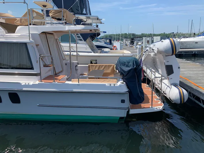 Gadabout Yacht Photos Pics 2024 Ranger Tugs R-29 CB docked, featuring a spacious deck and inflatable boat.