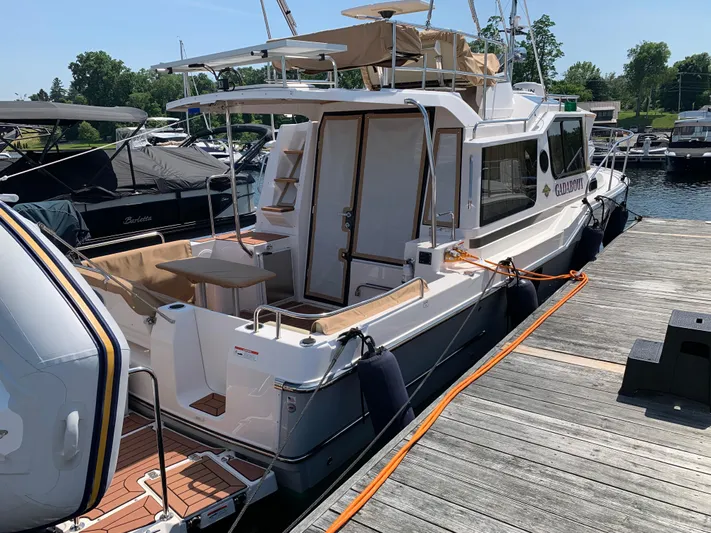 Gadabout Yacht Photos Pics 2024 Ranger Tugs R-29 CB docked at marina, featuring spacious deck and modern design.