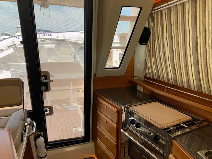Gadabout Yacht Photos Pics Interior of 2024 Ranger Tugs R-29 CB with kitchen and deck view.