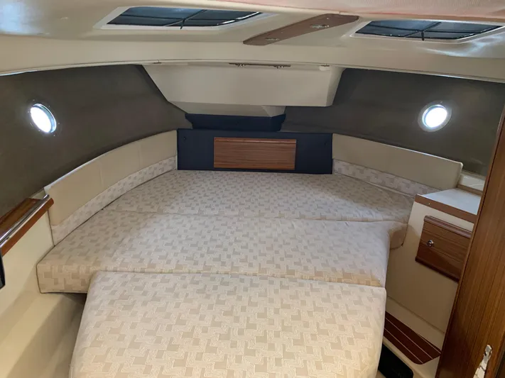 Gadabout Yacht Photos Pics 2024 Ranger Tugs R-29 CB cabin interior with spacious bed and elegant wood accents.