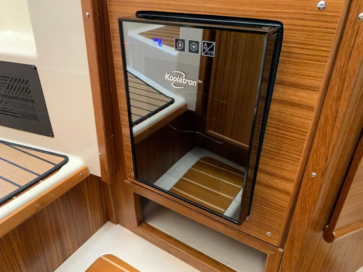 Gadabout Yacht Photos Pics 2024 Ranger Tugs R-29 CB interior with Koolatron fridge, wood paneling, and modern design.