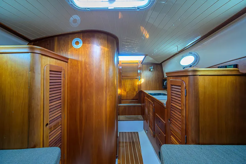 Lucky Town Yacht Photos Pics Interior of 2000 Hinckley Picnic Boat Classic with wooden cabinetry and cozy seating.