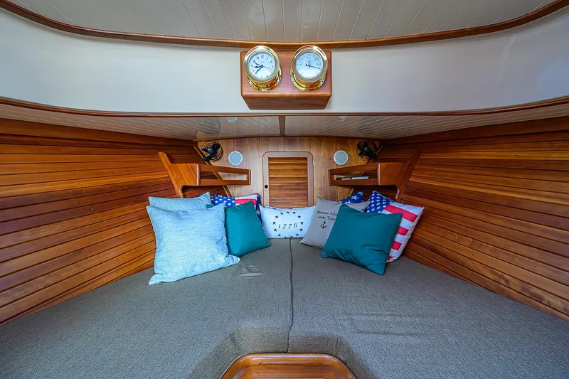Lucky Town Yacht Photos Pics Interior of 2000 Hinckley Picnic Boat Classic with cozy cushions and wooden paneling.