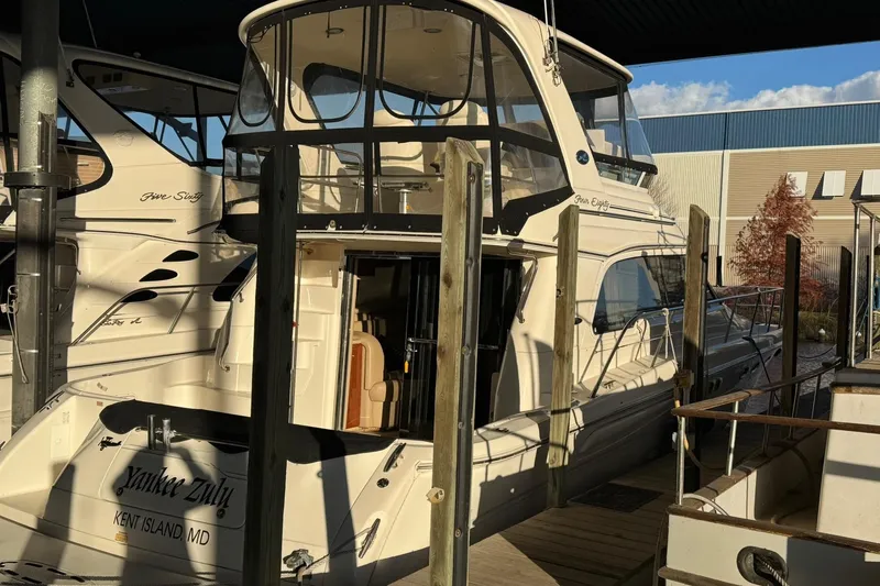  Yacht Photos Pics 2003 Sea Ray 480 Sedan Bridge yacht docked at marina, rear view.