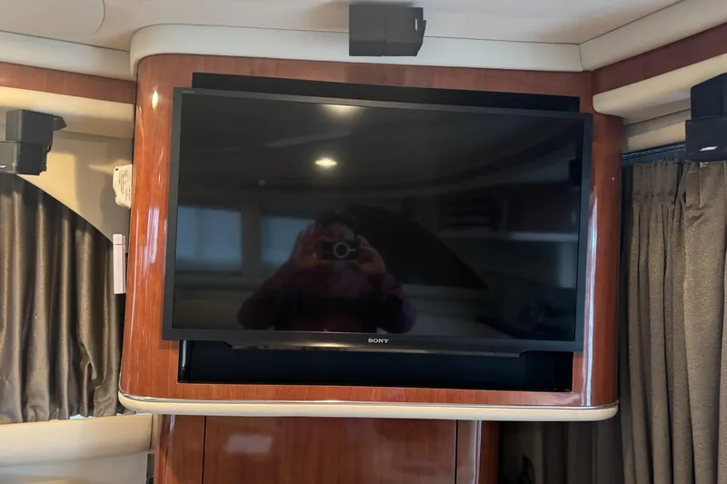  Yacht Photos Pics Sony TV in 2003 Sea Ray 480 Sedan Bridge yacht interior with wood paneling.