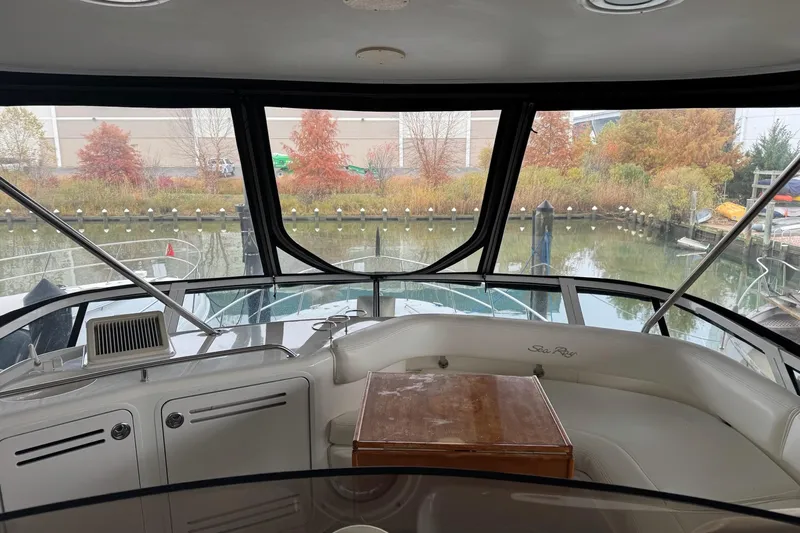  Yacht Photos Pics Interior view of 2003 Sea Ray 480 Sedan Bridge yacht with scenic marina backdrop.