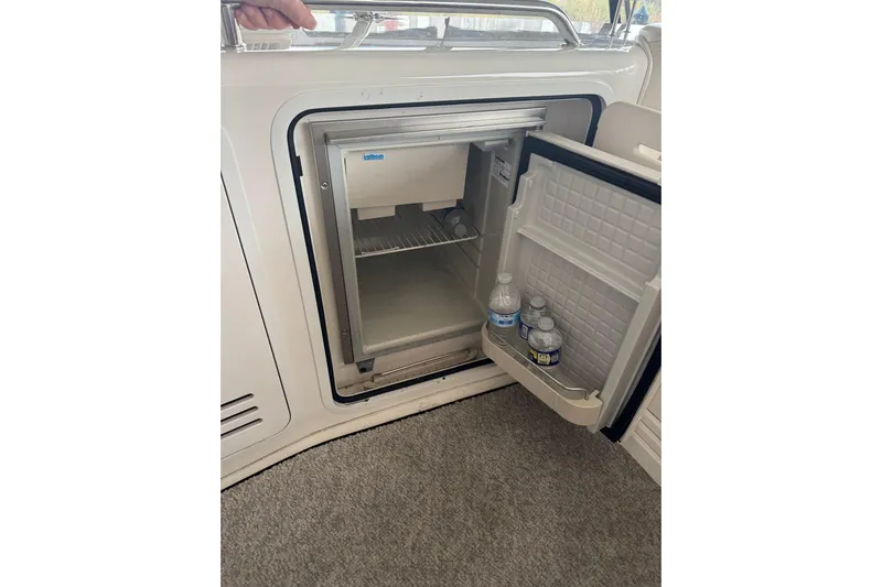  Yacht Photos Pics Open mini fridge on 2003 Sea Ray 480 Sedan Bridge with water bottles inside.